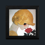 DAM MED RÖD ROS MINNESASK<br><div class="desc">Vibrant,  klassi Fransk Art Deco med hög mode. Porträtt om en vacker ung kvinna som bär en guldhatt med blomma,  svart vit,  gult,  grått färg .Coola,  modern och konstnärlig design.</div>
