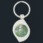 Dam till Claude Monet Painting Dans La Prairie Swirl Silverfärgad Nyckelring<br><div class="desc">Söt imponerande målning av ett Viktorianskt Dam som läser i en skugga. "Dans la prairie" betyder "In the meadow". Claude Monet,  i sitt oförytterliga stil fångar en perfekt sommardag. Dam bär sin bästa Söndag-vita klänning och bonnet. En ängsskugga fylld med vackra blommor,  inklusive daisy naturligtvis. Anpassa till namn.</div>