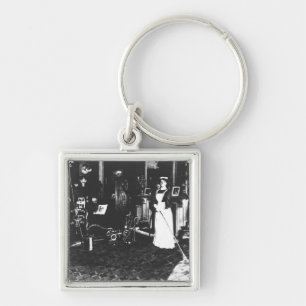 Dammsugare på arbete fyrkantig silverfärgad nyckelring