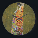 Där tid möter konst: Gustav Klimts Hope II Stor Klocka<br><div class="desc">Öka din livsmiljö med lite elegans och inspiration. Vår väggklocka har en häpnadsväckande återgivning av Gustav Klimts mästerverk, "Hope II", som är noggrant utformat med högkvalitativa detaljer och upplösning. Varje penseldrag kommer till liv med digitalt förbättrad precision, skapar den här tidsramen som ett verkligt konstverk. Den här klockan är inte...</div>