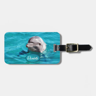 Delfin i blåttvattenfoto bagagebricka