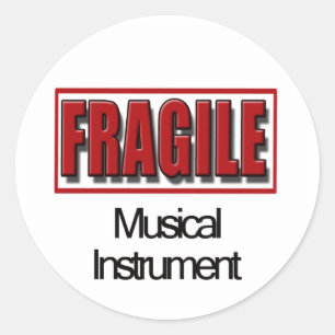 Den bräckliga musikalen instrumenterar runt klistermärke