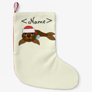 Den bruna babyen förseglar med den Santa hatten, & Liten Julstrumpa