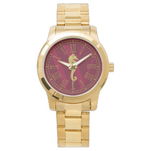 Den guld- Seahorsemonogramen personifierar Armbandsur