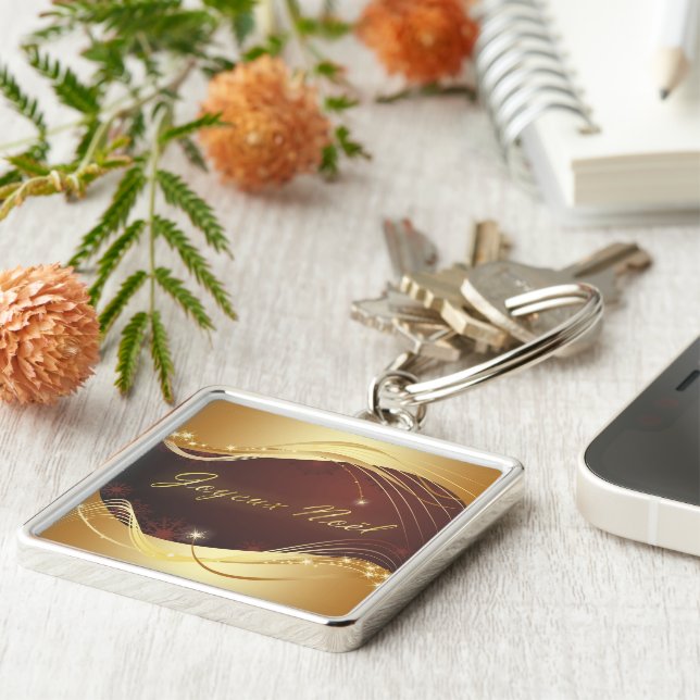 Den gyllene julmotivet med röd bakgrund... fyrkantig silverfärgad nyckelring (Sidan)