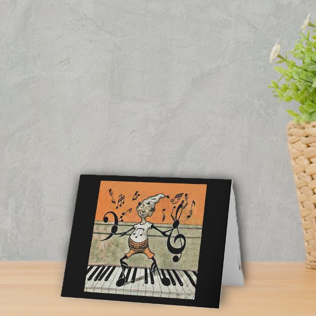 Den musikaliska älvan noterar på piano noterar helgkort (Fantasy Elf with music notes for arms and legs standing on piano keys on notecards.)