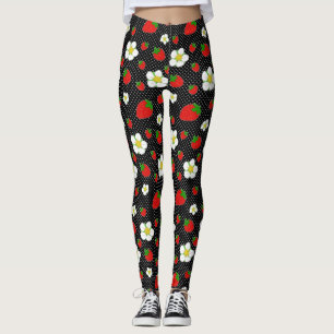 Den röda jordgubben pricker i svart leggings