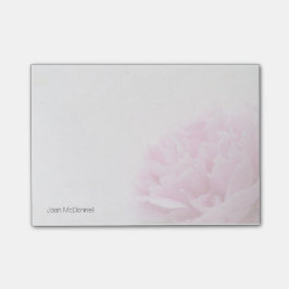 Den rosa pionen beskådar bleknar post-it block