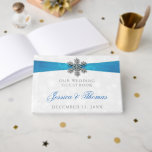 Diamante Snowflake & Blue Ribbon Winter Wedding Gästböcker<br><div class="desc">Röntsnöflingan och blåraket bröllop är perfekt för alla par som planerar ett romantiskt vinterbröllop firande. Utformningen har en lätt silvud-grått och en vit snöflingor med en romante-snöflake ovanpå ett silkesaktigt tittar band. Ordalydelsen innehåller samma grått- och blått färg av formgivningen och kan lätt användas som personlig för att passa din...</div>