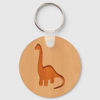 Dinosaur silhouette ingraverat på trädesign nyckelring