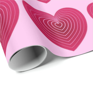 Djupa ro-röda hjärtan på blekens rosa presentpapper
