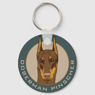 Dobermanemblem som är rött nyckelring