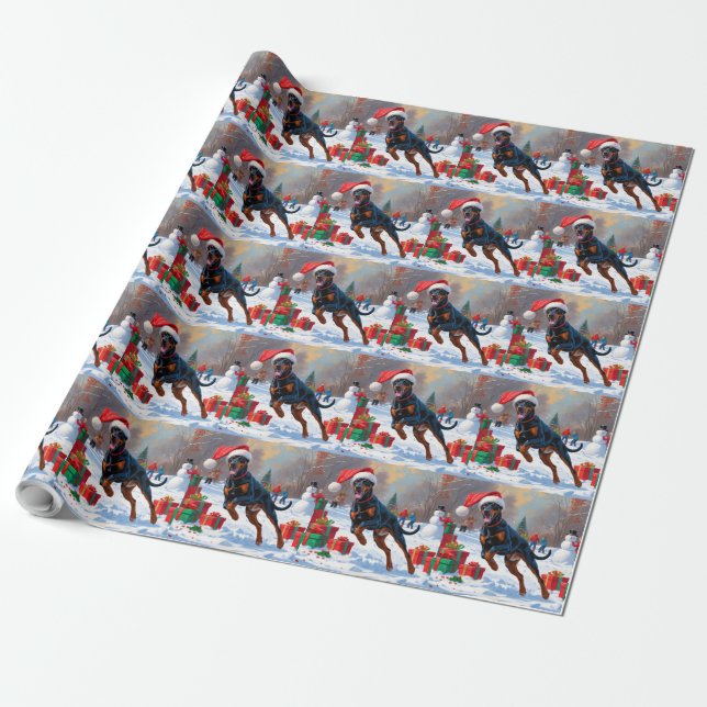 Dobermann springer i snö med julhatt presentpapper (Utrullad)