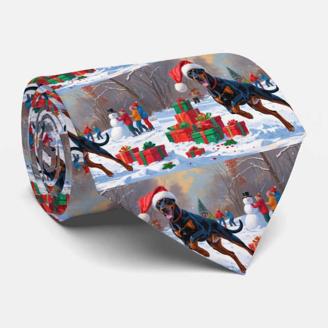 Dobermann springer i snö med julhatt slips (Rullad)