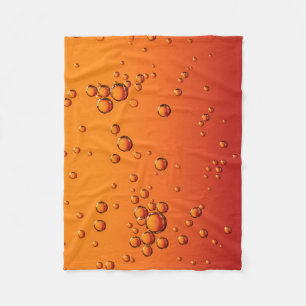 droppar i vatten på orange yta fleecefilt