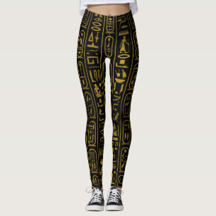 Egyptiska forntida guld- hieroglyphs på svart leggings