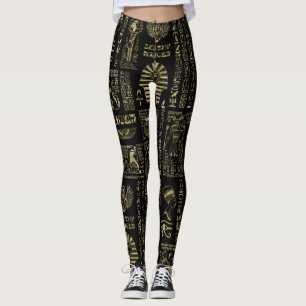 Egyptiska hieroglyphs och gudomar som är guld- på leggings