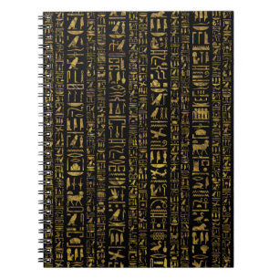Egyptiskt hieroglyphsvintageguld på svart anteckningsbok