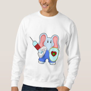 Elefant vid vaccinering med spruta lång ärmad tröja
