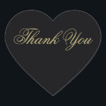 Elegant Black och Guld Monogram Tack Hjärtformat Klistermärke<br><div class="desc">Den här eleganten är det hjärtformade tack som du klistrar in i guld på svart. Det kommer att vara perfektens beröring till dina tackkort. En del av vår Elegant Black & Guld Heart Flourish bröllopssviten designad av konstnären Susan Coffey.</div>