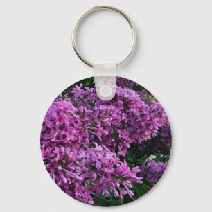 Elegant blommigt av djupa lila magenta: blommor, l nyckelring
