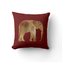 Elegant guld elefant på vinröd bakgrund