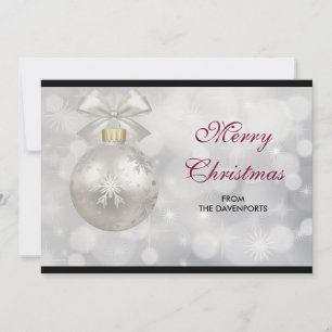 Elegant silver julgranskula mot bokeh-ljus julkort