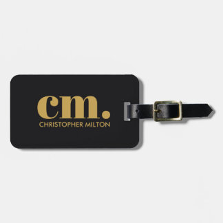 Elegant svart gyllene fet monogram bagagebricka