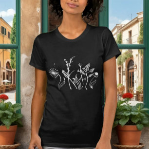 Elegant svart t-shirt med ömtåliga klotterblommor