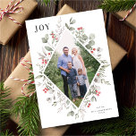 Elegant Winter Watercolor Greenery White Photo Julkort<br><div class="desc">Den här eleganten och det här fotokortet för frammatning av helgdag har en vacker vattenfärggeometrisk ram av holly, eukalyptus och bär över en klassisk vit bakgrund. Den redigerbara hälsning på framsidan säger "JOY". Kortets baksida är ett festligt rött färg. Du kan också lägga till ett annat foto och/eller ytterligare text...</div>