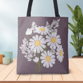 Eleganta blommande vita prästkragar på plommon tygkasse
