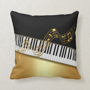 Eleganta guldbetonade noter, pianotangent, svart kudde