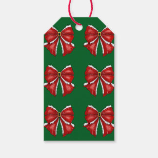 Eleganta röda julslingor på mörkgrönt presentetikett