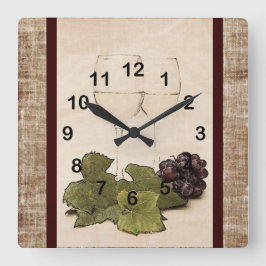 eleganta wineglasses med druvan tar tid på fyrkantig klocka