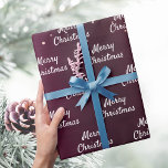 Eleganten ro guld vid jul presentpapper<br><div class="desc">papper förpackning av elegant,  klassisk,  glamorös och stil party. En burgundisk bakgrund som dekorerats med ro guld konetti Text: God jul</div>