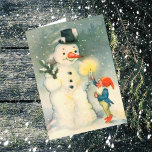 Elf- och Snögubbe-julkort Helgkort<br><div class="desc">Här är ett sött Viktorianskt julkort med bilden av en av jultomtens älvar som håller ett tänt ljus för ett snögubbe att se. Roligt att fira Helgdagarna på gammaldags sätt! Anpassa enkelt det invändiga meddelandet till kostym om din smak eller lämna som den är. För hundratals vintagar och contemporary jul...</div>