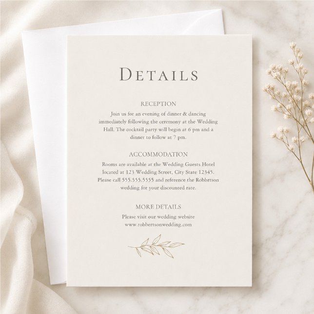 Elfenbens- & antika guld botaniska informationskor inbjudningar (Ivory & Antique Gold Botanical Details Card on a marble table with tiny white flowers)