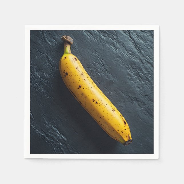 En banan på en mörk yta pappersservett (Framsidan)