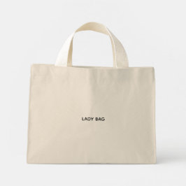 En beige toteväska med vita handtag  mini tygkasse