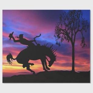 En cowboysilhouette på solnedgången presentpapper