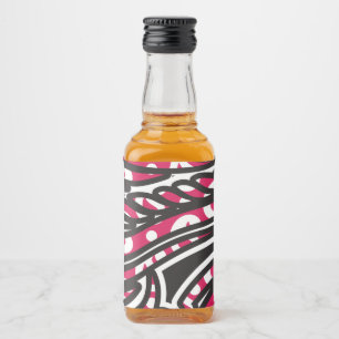 En dekorativ paisley-design med levande rött och s spritflaskor etikett