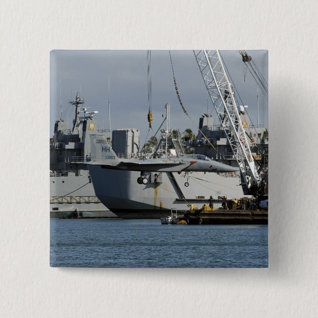 En F-15 Eagle får hiss från en pråm. Knapp (Framsida)