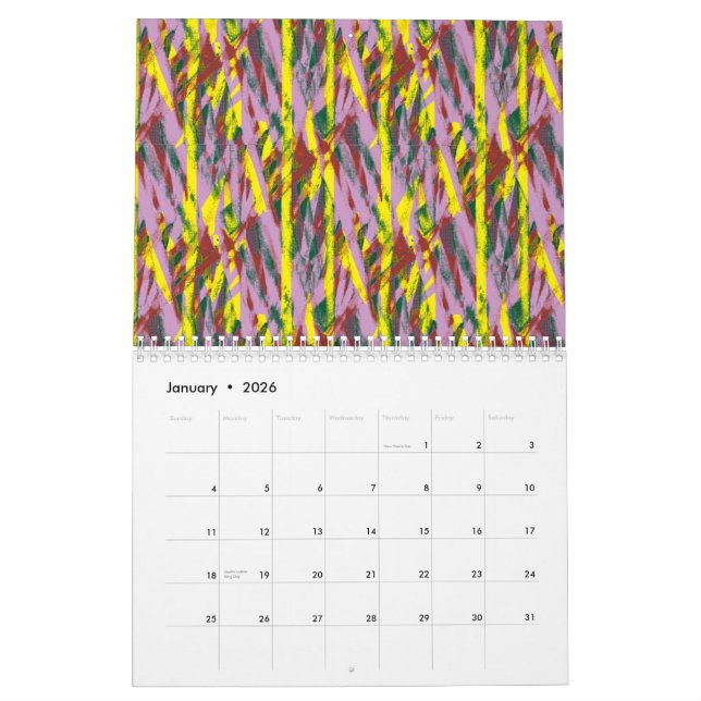 En fluffy grått- katt med grönt ögon sitter på ett kalender (Jan 2026)