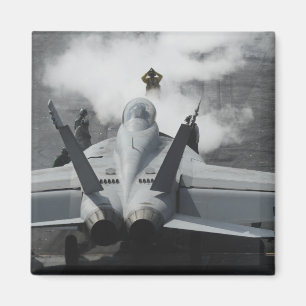En flygdäckdirektör signalerar en F/A-18F Magnet