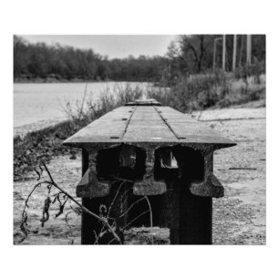 En glömd gammal järnvägsbänk längs en flod. fototryck