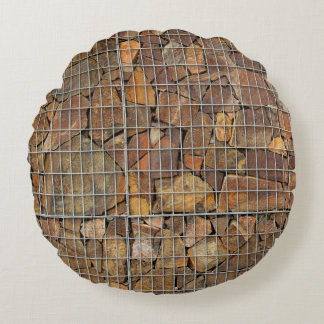 En grungande tegelvägg i struktur som grundförutsä rund kudde