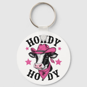 En ko som bär en vibrerande rosa cowboy nyckelring