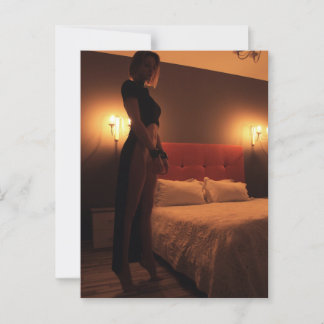 En kvinna i en svart kloak i ett mörk rum vykort