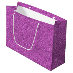En lila glitterpresentbag med vita handtag