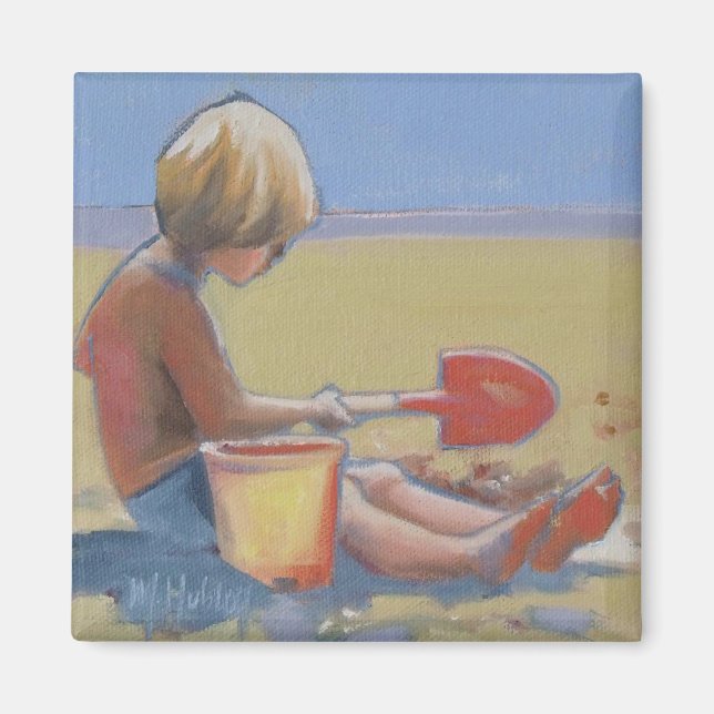 En liten pojke som leker i sanden med en shovel magnet (Framsidan)